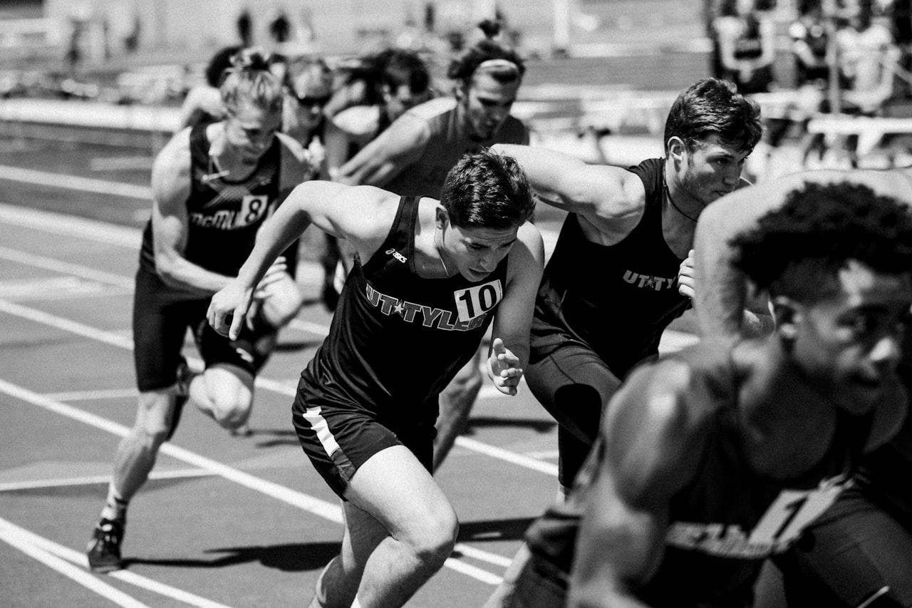Runners racing in a pack on the track